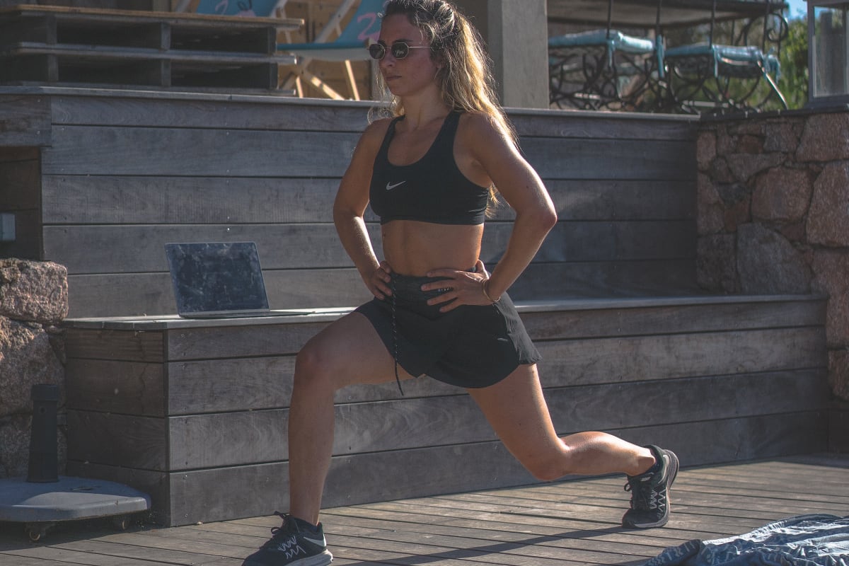 Female athlete performing bodyweight lunges